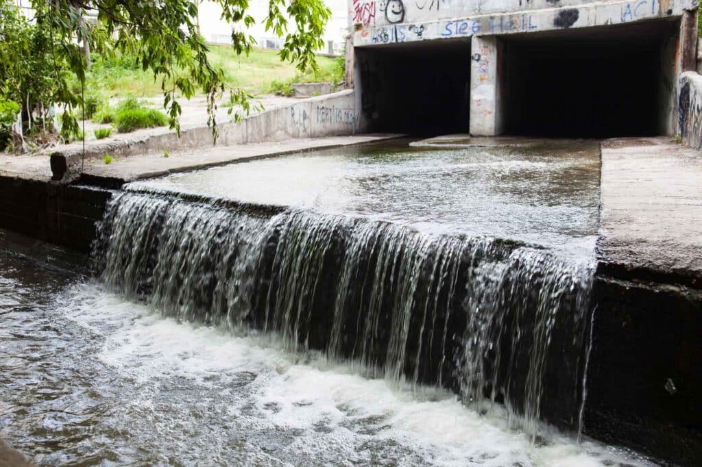 Water stream flowing out the underground tunnel