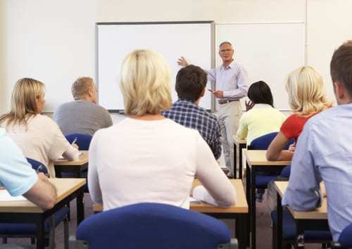 classroom of adult students learning from teacher