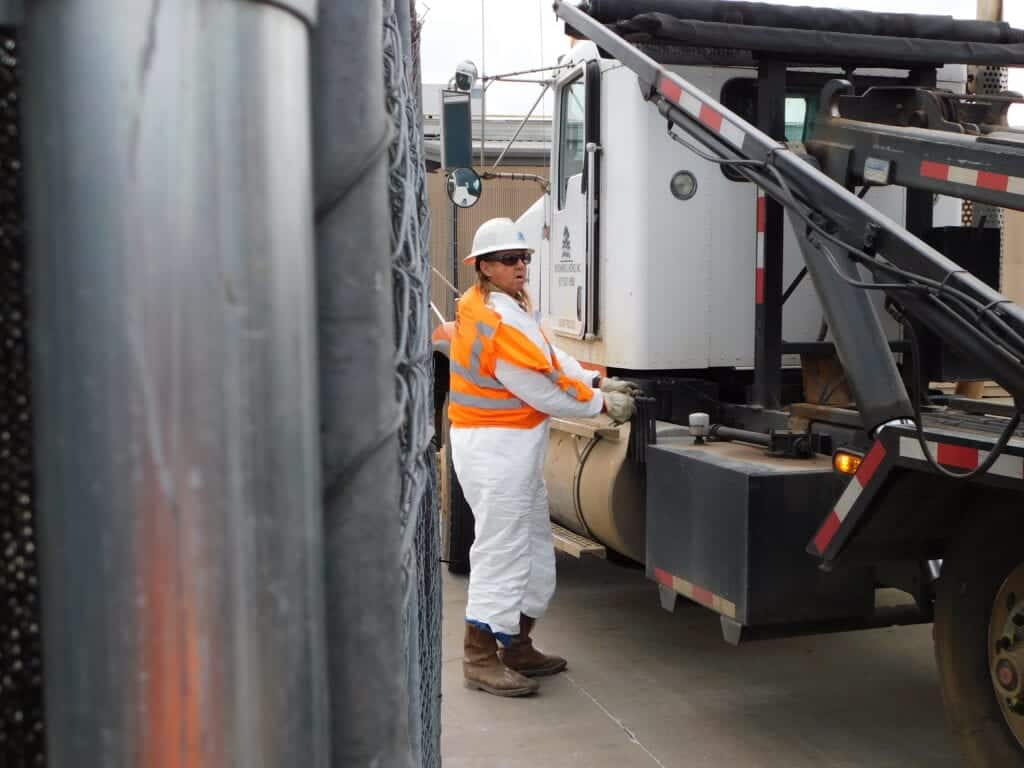 Stephen operates the roll-off hoist on an EWI truck.