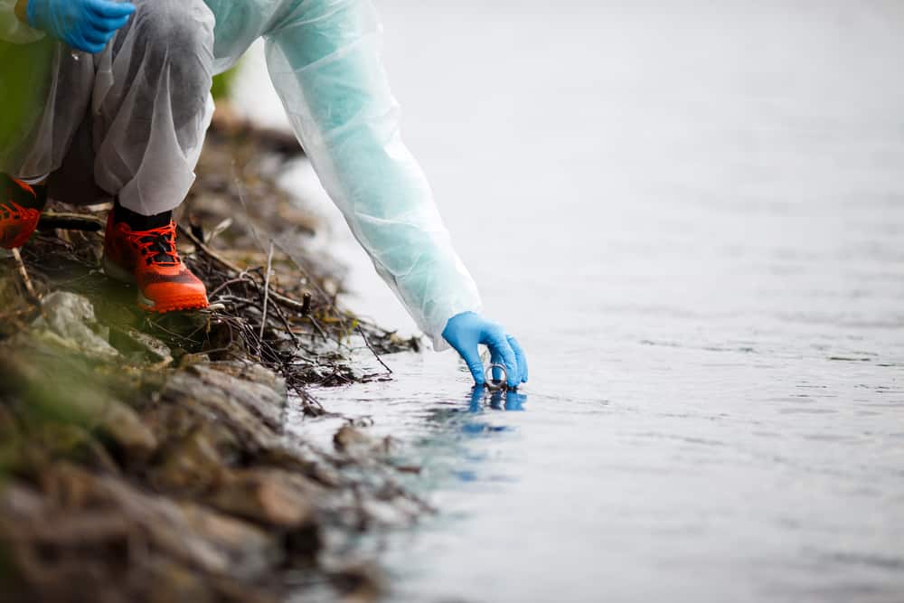 Lab assistant taking water sample