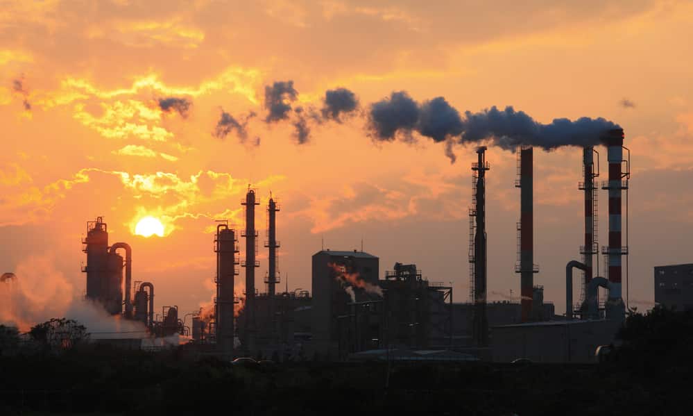 Sunrise, factory emitting pollution