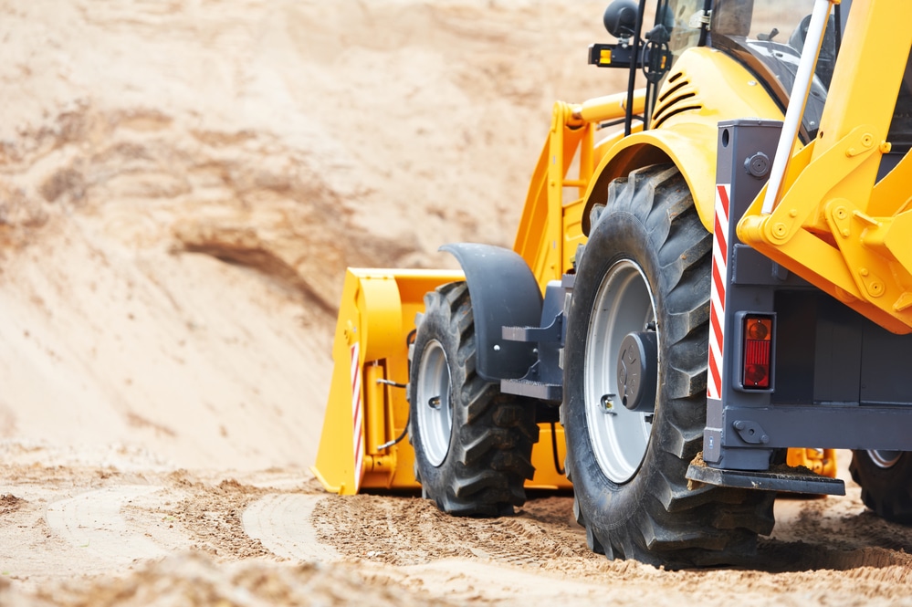 close-up of excavator loader moving soil